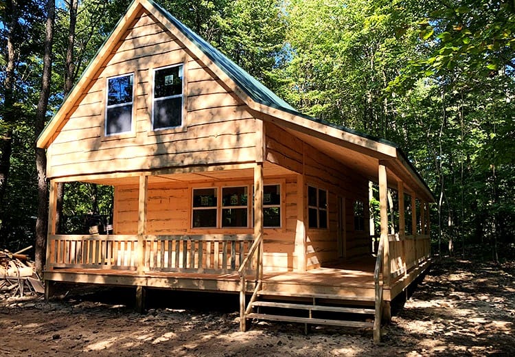 The Autumn Lodge: A Charming $65K Cabin with a Wraparound Porch